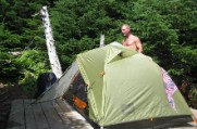 An old man sets up our tent