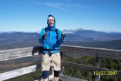 Nate on Ranger Tower with Mt Washington as backdrop