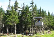 Ed in a shooting hut with hiking pole