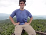 Ed perched precariously on top of old fire tower frame on Snow