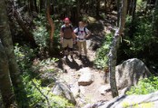 Bruce photos the crew from a trail side boulder