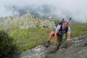 Bruce comes over the lip of a rock face climb on the Caps Ridge Trail