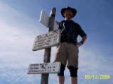 Nate towers over the landscape at the summit of Mt Adams