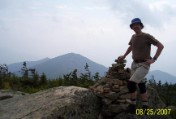 Nate at Mt Bond summit cairn, Mt Bondcliff in background