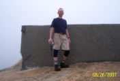 Nate on the cold, wet, windy, obscured summit of Mt Garfield