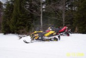 Sleds rest while the boys make yellow snow